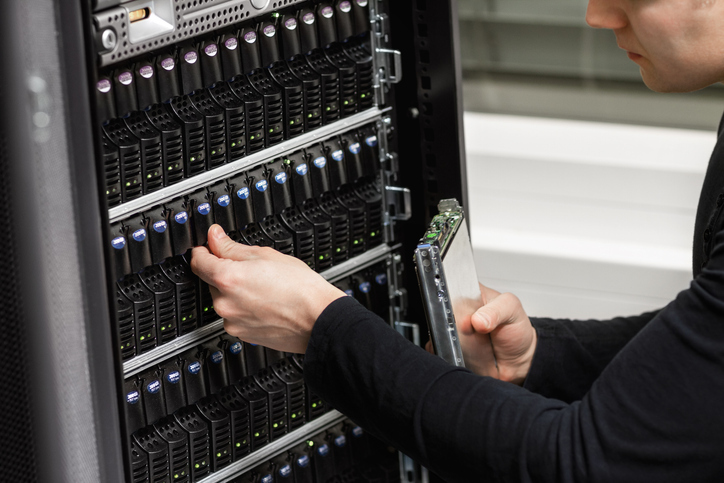 Male IT Technician Analyzing SAN in Datacenter